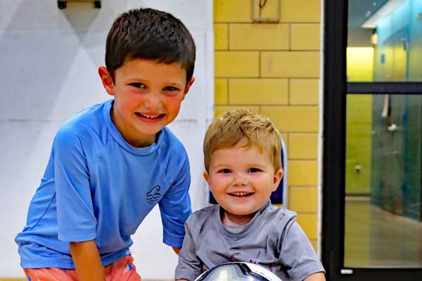 Two boys enjoying playcare child care at Ellis Athletic Center